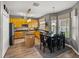Kitchen with island, stainless appliances, wood cabinetry, and connected dining area at 27231 Liriope Ct, Wesley Chapel, FL 33544