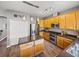 Open kitchen with stainless steel appliances, island with bar seating and spacious layout at 27231 Liriope Ct, Wesley Chapel, FL 33544