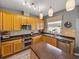 Bright kitchen featuring stainless steel appliances, island with bar seating, and window at 27231 Liriope Ct, Wesley Chapel, FL 33544