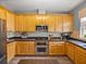 Well-equipped kitchen featuring stainless appliances, stylish cabinets, and decorative backsplash at 27231 Liriope Ct, Wesley Chapel, FL 33544