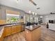 Open-concept kitchen with island seating, stainless appliances, and access to the dining area at 27231 Liriope Ct, Wesley Chapel, FL 33544