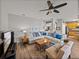 Cozy living room with a neutral color palette, comfortable seating, and adjacent eat-in kitchen at 27231 Liriope Ct, Wesley Chapel, FL 33544