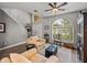 Cozy living room with large windows, hardwood floors, and comfortable seating at 27231 Liriope Ct, Wesley Chapel, FL 33544