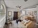 Bright living room featuring a ceiling fan and hardwood flooring at 27231 Liriope Ct, Wesley Chapel, FL 33544