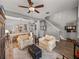 Open-concept living room with hardwood flooring and access to the dining room at 27231 Liriope Ct, Wesley Chapel, FL 33544