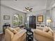 Bright living room featuring hardwood flooring and comfortable seating at 27231 Liriope Ct, Wesley Chapel, FL 33544