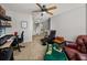 Second view of carpeted office featuring a ceiling fan, desk, and comfortable seating at 27231 Liriope Ct, Wesley Chapel, FL 33544