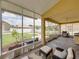 Screened-in patio with seating area, tile flooring, and view of landscaped backyard and fence at 27231 Liriope Ct, Wesley Chapel, FL 33544