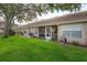 Lush green backyard with screened-in porch, providing a private and peaceful outdoor space at 3073 Overlook Pl, Clearwater, FL 33760