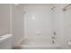 Full tub and shower with white tile surround at 3073 Overlook Pl, Clearwater, FL 33760