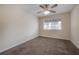 Bedroom featuring a ceiling fan, carpet flooring, and a large window at 3073 Overlook Pl, Clearwater, FL 33760