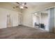 Spacious bedroom featuring a ceiling fan, neutral carpet, and sliding glass doors to a private lanai at 3073 Overlook Pl, Clearwater, FL 33760
