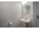 Half bathroom features a pedestal sink and toilet paper holder at 3073 Overlook Pl, Clearwater, FL 33760