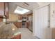 Open kitchen with stainless steel appliances, wooden cabinets, granite countertops, and skylight at 3073 Overlook Pl, Clearwater, FL 33760