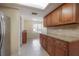 Kitchen with stainless steel refrigerator, granite counters, wood cabinets, and a sun roof at 3073 Overlook Pl, Clearwater, FL 33760