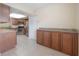 Bright kitchen featuring wooden cabinets, granite countertops, stainless steel appliances, and tiled floors at 3073 Overlook Pl, Clearwater, FL 33760