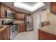 Galley kitchen features stainless steel appliances, granite countertops, and wooden cabinets at 3073 Overlook Pl, Clearwater, FL 33760