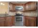 Well-equipped kitchen with stainless steel appliances and updated wood cabinetry at 3073 Overlook Pl, Clearwater, FL 33760