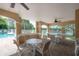 Covered patio with seating, perfect for relaxing by the pool and enjoying the lake view at 3073 Overlook Pl, Clearwater, FL 33760