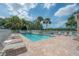 Community pool with lounge chairs and clear blue skies, creating a serene outdoor space at 3073 Overlook Pl, Clearwater, FL 33760