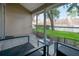 Relaxing screened porch with outdoor seating overlooking a serene backyard with well-maintained landscaping at 3073 Overlook Pl, Clearwater, FL 33760