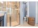 Bathroom featuring a glass door shower with tile surround, a storage basket, and a separate toilet room at 31050 Spruceberry Ct, Wesley Chapel, FL 33543