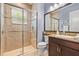 The bathroom features tile flooring, a vanity with granite countertop and a glass door shower at 31050 Spruceberry Ct, Wesley Chapel, FL 33543