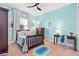 This bedroom features carpet, a ceiling fan, a desk and a window at 31050 Spruceberry Ct, Wesley Chapel, FL 33543