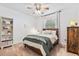 This bedroom features carpet, a wooden bedframe, a ceiling fan and a window at 31050 Spruceberry Ct, Wesley Chapel, FL 33543