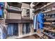 Custom walk-in closet with dark wood shelves and clothing racks for maximum storage at 31050 Spruceberry Ct, Wesley Chapel, FL 33543