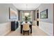 Open dining room with a view into the kitchen, stylish light fixture, and neutral decor at 31050 Spruceberry Ct, Wesley Chapel, FL 33543