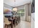 Open dining room with a view into the kitchen, stylish light fixture, and neutral decor at 31050 Spruceberry Ct, Wesley Chapel, FL 33543