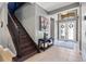 This foyer features tile flooring, stairs and a double door entry at 31050 Spruceberry Ct, Wesley Chapel, FL 33543