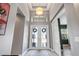Bright foyer with double glass doors and transom, plus a high ceiling and pendant lighting at 31050 Spruceberry Ct, Wesley Chapel, FL 33543