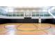 Indoor basketball court featuring a hardwood floor, basketball hoops and colored lines at 31050 Spruceberry Ct, Wesley Chapel, FL 33543