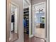 Hallway view of walk-in closets with custom shelving and a soaking tub bathroom at 31050 Spruceberry Ct, Wesley Chapel, FL 33543
