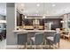 Stylish kitchen featuring dark wood cabinets, stainless steel appliances, and bar seating at 31050 Spruceberry Ct, Wesley Chapel, FL 33543