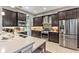 Modern kitchen featuring stainless steel appliances, dark wood cabinetry, and stylish backsplash at 31050 Spruceberry Ct, Wesley Chapel, FL 33543