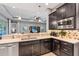 Open kitchen with stainless steel appliances, granite countertops, and seamless view to the living room at 31050 Spruceberry Ct, Wesley Chapel, FL 33543