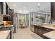 Bright kitchen featuring stainless steel appliances, a dining area, and views to the living area at 31050 Spruceberry Ct, Wesley Chapel, FL 33543