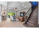 The living room features tile flooring, a ceiling fan and leather seating at 31050 Spruceberry Ct, Wesley Chapel, FL 33543