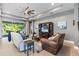 Spacious living room with a ceiling fan, neutral paint, and access to the backyard at 31050 Spruceberry Ct, Wesley Chapel, FL 33543
