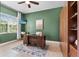 This office features wooden accents, green walls, a desk, and a murphy bed at 31050 Spruceberry Ct, Wesley Chapel, FL 33543