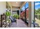 Relaxing screened patio features brick flooring, comfortable seating, and lush plants, creating a serene outdoor living space at 31050 Spruceberry Ct, Wesley Chapel, FL 33543