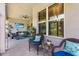 Inviting covered patio boasts brick flooring, comfortable seating, and a ceiling fan for pleasant outdoor relaxation at 31050 Spruceberry Ct, Wesley Chapel, FL 33543