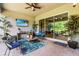 Inviting outdoor patio with stylish furniture, tropical plants, and a relaxing atmosphere for enjoying the outdoors at 31050 Spruceberry Ct, Wesley Chapel, FL 33543