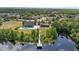 Gorgeous aerial view showcasing a clubhouse, pool, gazebo, and dock access to the serene community pond at 3142 Stonegate Falls Dr, Land O Lakes, FL 34638