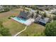 Aerial view of the community pool, clubhouse, and playground area, surrounded by well-maintained landscaping at 3142 Stonegate Falls Dr, Land O Lakes, FL 34638
