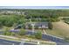 Aerial shot of community amenities including pool, clubhouse, playground, parking area and surrounding lush green landscape at 3142 Stonegate Falls Dr, Land O Lakes, FL 34638