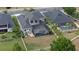Aerial view of backyard with screened-in pool and lush green lawn surrounded by a white picket fence at 3142 Stonegate Falls Dr, Land O Lakes, FL 34638